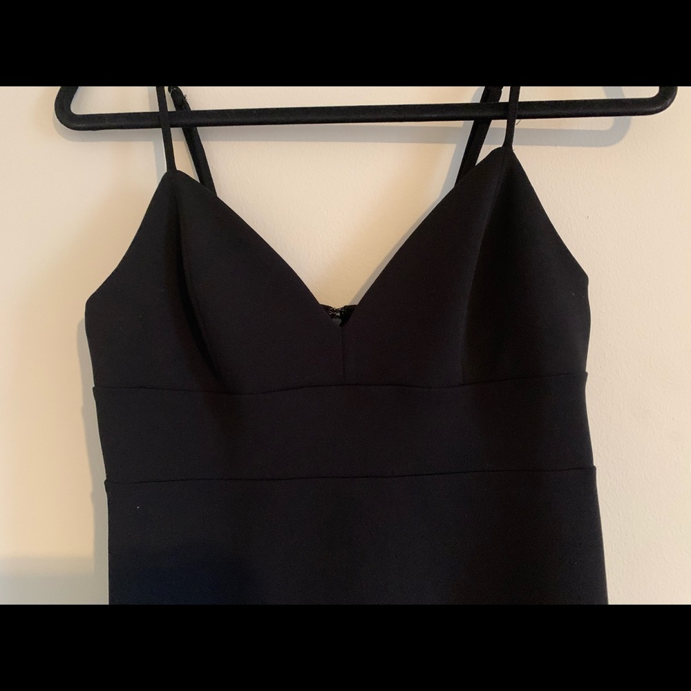 Black mini dress with dropped, ruffle hem